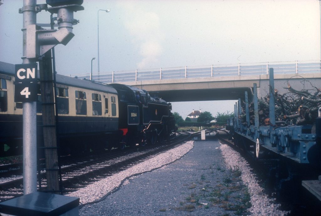 80064 and its coaches beside a signal post, with a concrete road bridge beyond.
